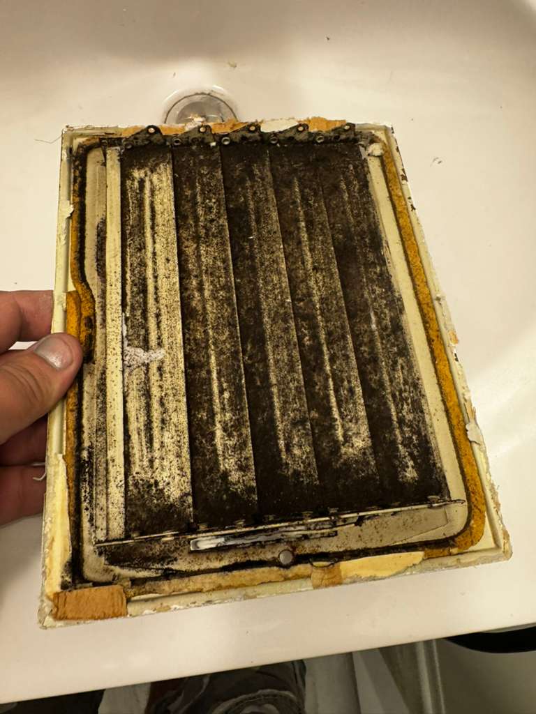Before: a clogged return-air filter pulled from a Maryland home — dust caked into the pleats — Eagle Air Duct Cleaning real job